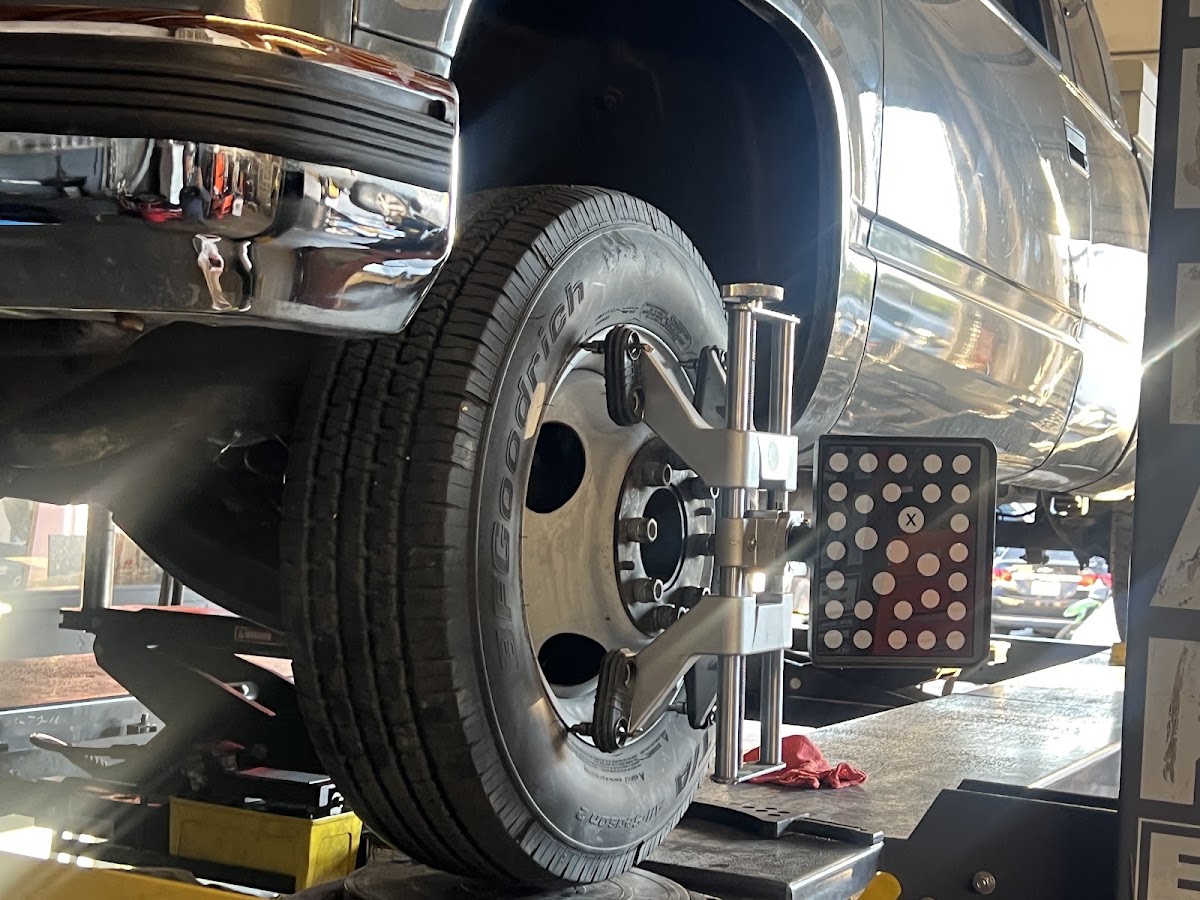 An alignment target clamped to a wheel at Intake Auto Repair