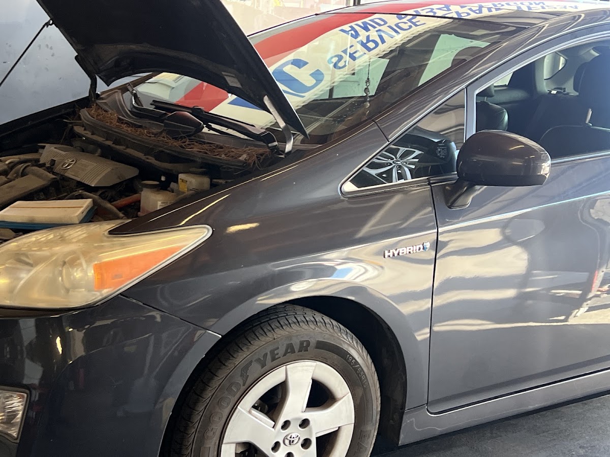 A Toyota Prius hybrid in for service with the hood open