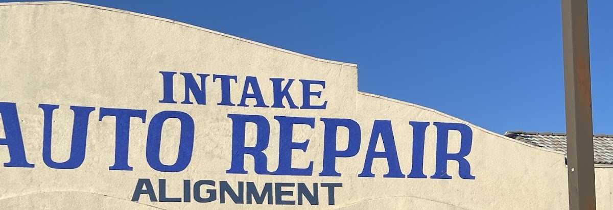 The painted Intake Auto Repair Alignment sign on the front of the shop