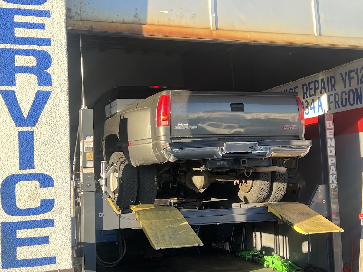 A pickup truck raised on the alignment rack at Intake Auto Repair